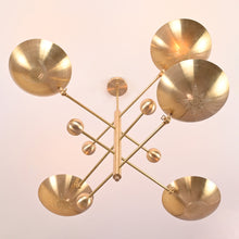 Celestial 5-light brass chandelier with star and moon perforated shades, handcrafted by Brass Leaf Studio.