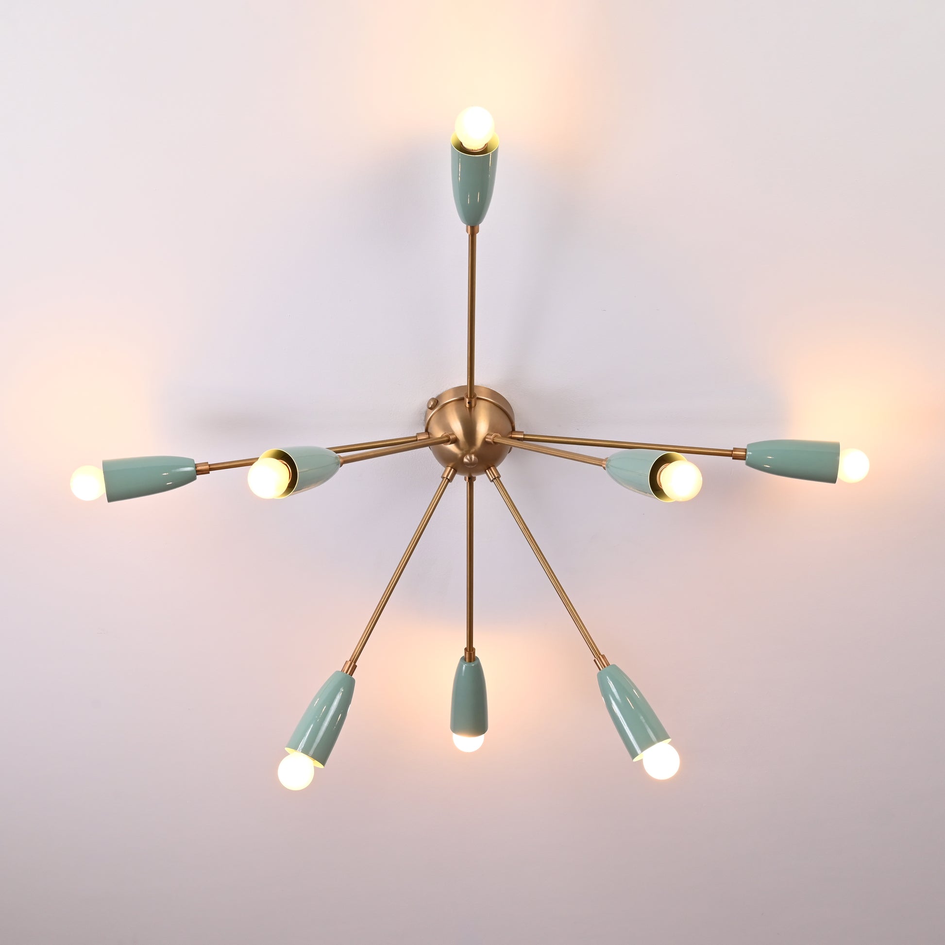 Detailed size guide of sputnik chandelier showing 37 inches width and 16 inches height with mint green shades and brass arms on a neutral ceiling