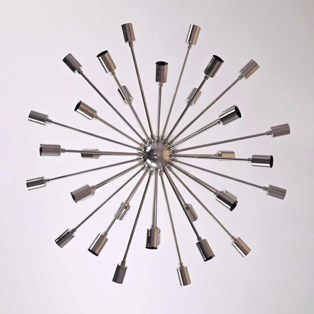 Top view of chrome Sputnik chandelier displaying 36 radiating brass arms in a modern geometric arrangement