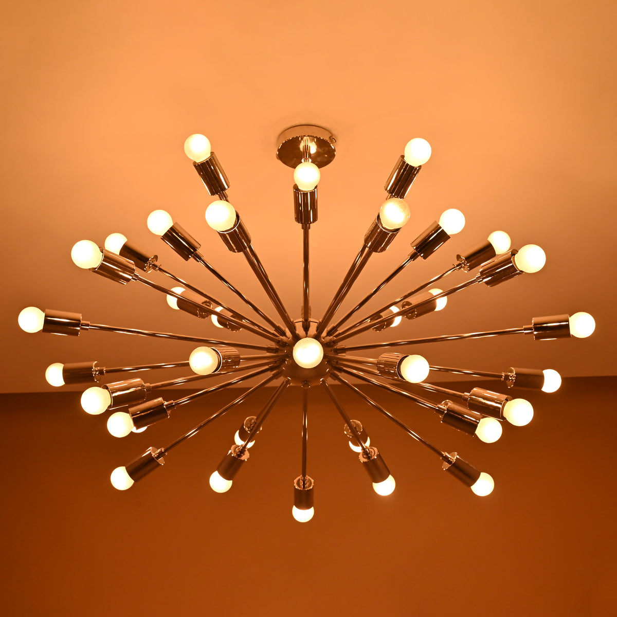 Warm ambient lighting view of 36-light chrome Sputnik chandelier enhancing modern living space decor