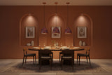 Colorful copper dome pendant lamp installed in a warm restaurant interior with red and blue patterned shade