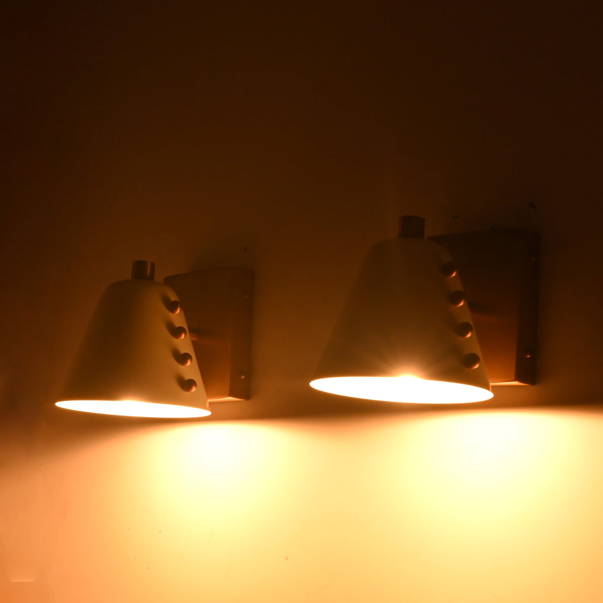 Compact wall sconce set for modern homes, featuring tapered shades, warm light, and elegant wall-mounted design