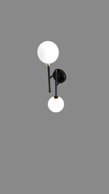 Front view of contemporary black and brass wall light featuring two frosted glass globes and minimalist vertical frame.
