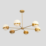 Contemporary brass ceiling light with six globe shades, minimalist modern chandelier design.