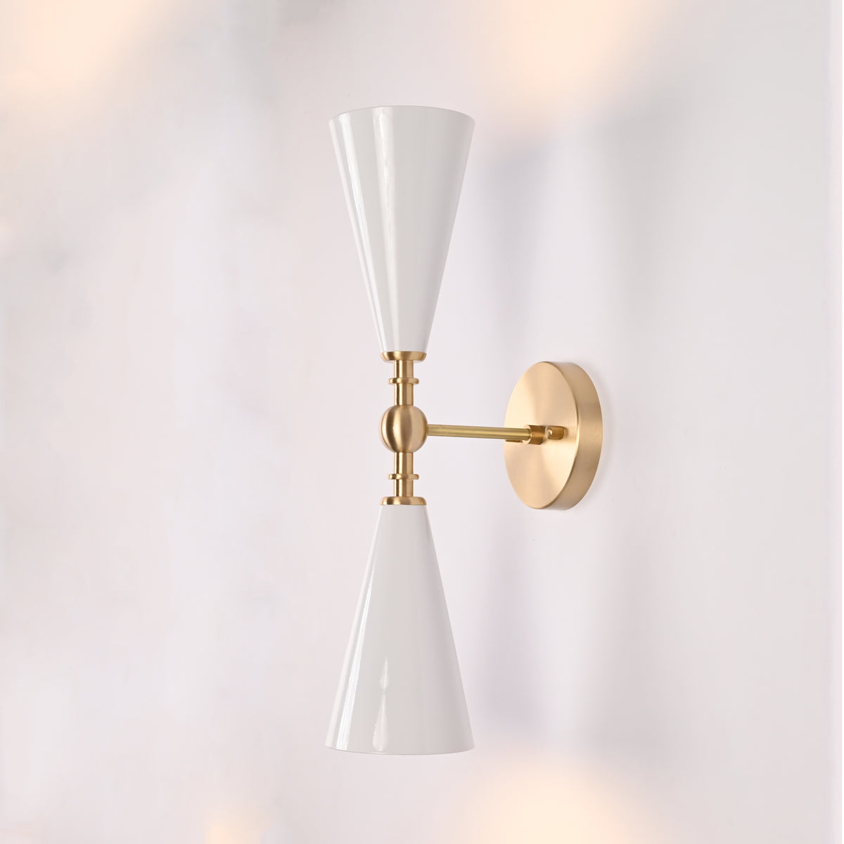 Copenhagen double cone wall sconce shown in restaurant interior with warm up and down lighting effect