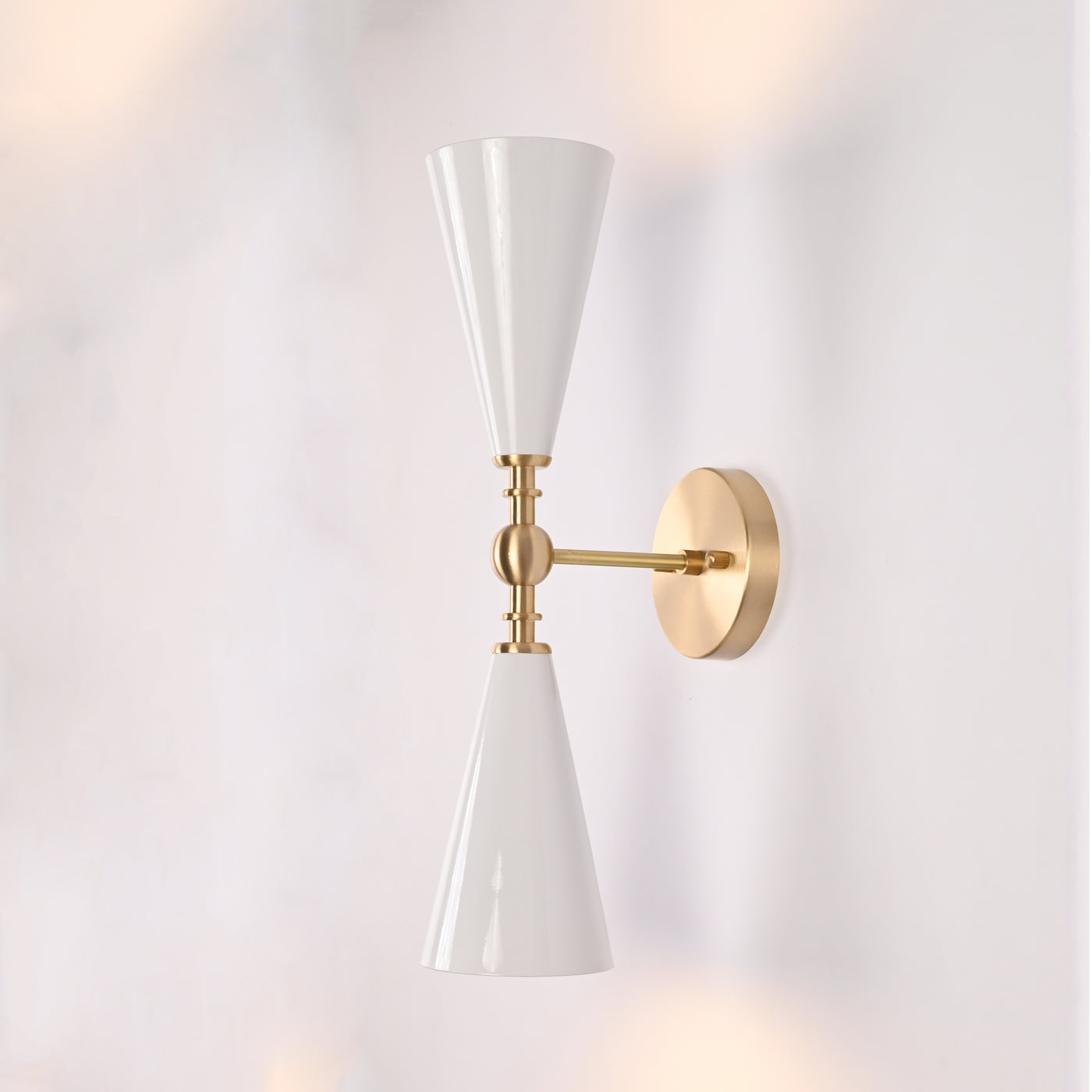 Copenhagen double cone wall sconce shown in restaurant interior with warm up and down lighting effect