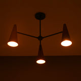 Close-up of glowing copper cone shade highlighting warm light diffusion and brass craftsmanship