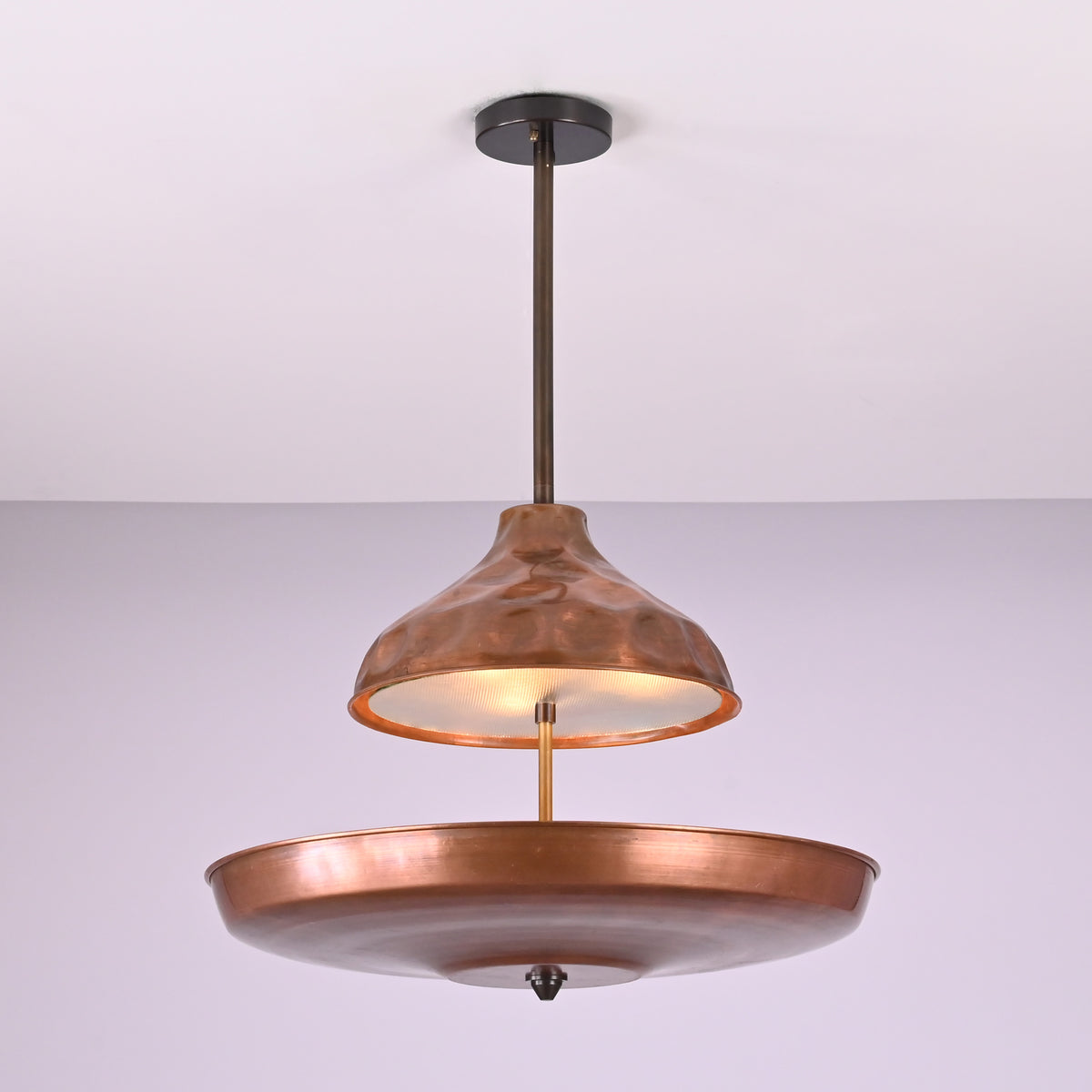 Underside view of handcrafted copper disc chandelier highlighting solid brass construction and smooth bowl form