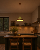Copper dome pendant light switched on, casting a warm downward glow from its wide rounded shade
