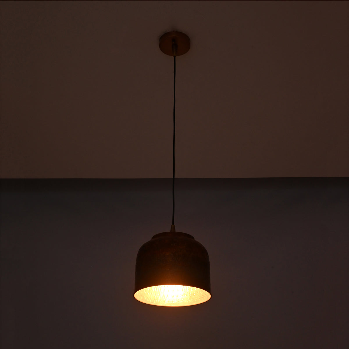 Copper drum pendant light front view showing rounded shade, black hanging cord, and matching ceiling canopy