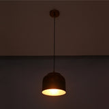 Copper drum pendant light front view showing rounded shade, black hanging cord, and matching ceiling canopy