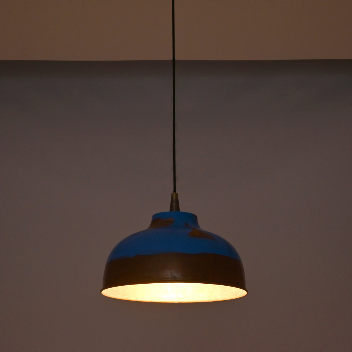 Multiple blue copper pendant lights arranged above a kitchen island for stylish task lighting