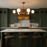 Copper patina brass ceiling light with six white glass globe shades arranged in a modern sputnik design