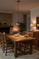 Copper pendant lamp installed above a kitchen island with blue green patina shade and warm focused lighting