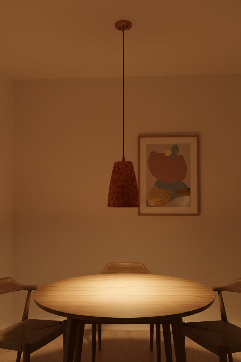 Copper pendant light hanging in a hallway with rich red patterned shade and warm focused illumination