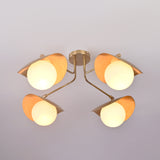 Bottom view of Curva brass flush mount revealing symmetrical globe layout and softly diffused ambient lighting.