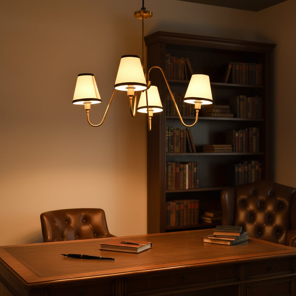 Closeup of curved arm brass chandelier with cream fabric shades, black shade trim, and refined classic detailing