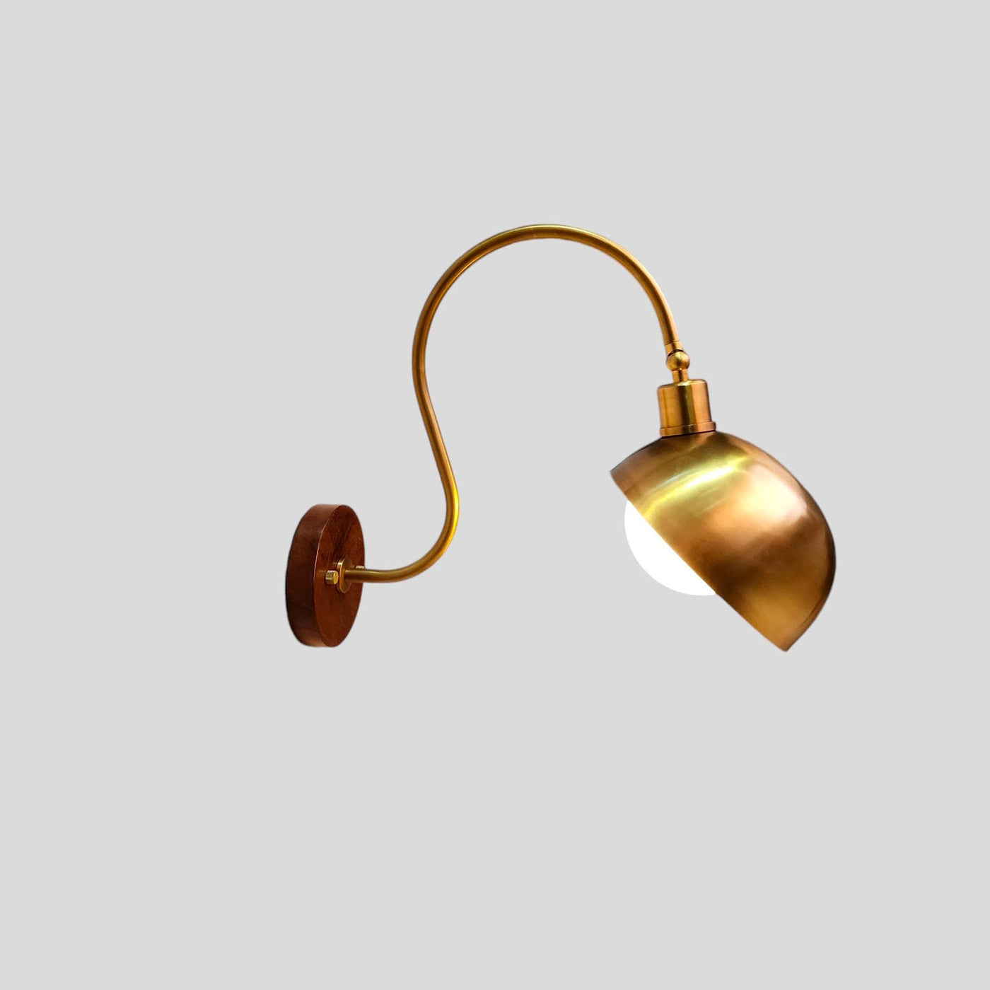 Handmade brass wall sconce with curved arm and dome shade – front view
