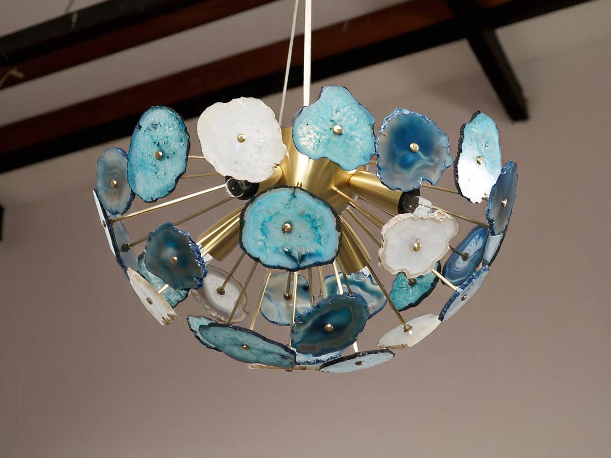 Custom brass agate flush mount chandelier installed in an interior space with layered blue and white stone detailing