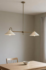 Custom brass cone chandelier with two lights styled in a modern minimalist interior setting