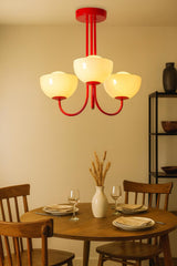 Custom color 3-light bowl glass chandelier showcasing a bold painted finish over a dining table