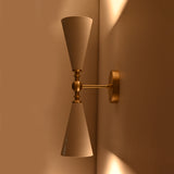 Customizable double cone wall sconce with enamel painted shades and brushed brass finish details