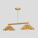 Customizable brass pendant chandelier with ruffled cone shades and round globe lights, minimalist yet artistic design.