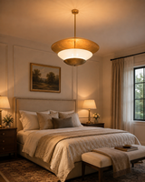 Customizable disc pendant light with brass finish, layered shade structure, and elegant warm glow for luxury spaces