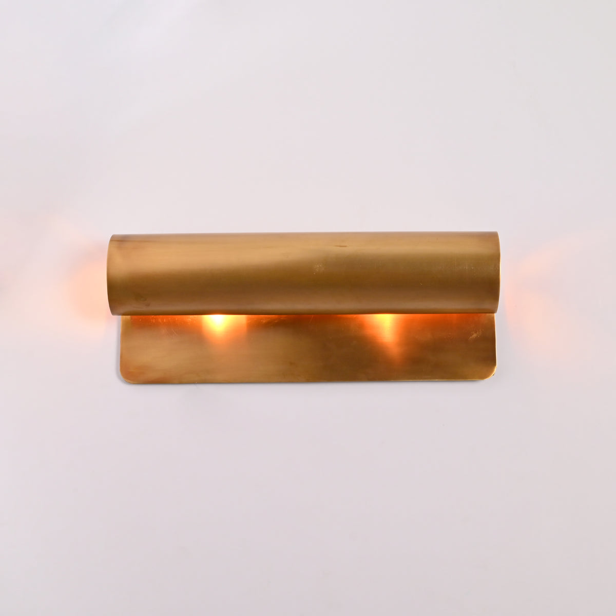 Customizable linear up down wall light with solid brass construction and warm ambient lighting effect