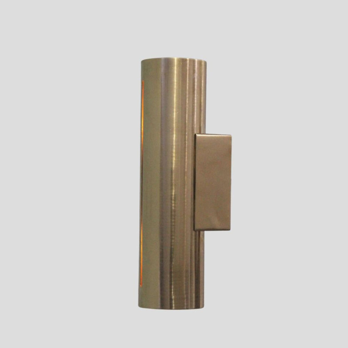 Contemporary brass wall lamp with sleek cylindrical design and subtle glowing slit for ambient indirect lighting.