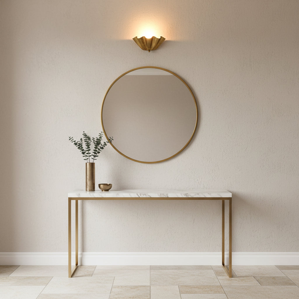 Decorative ruffled wall sconce with 12 inch brass patina shade and soft upward wall-wash glow