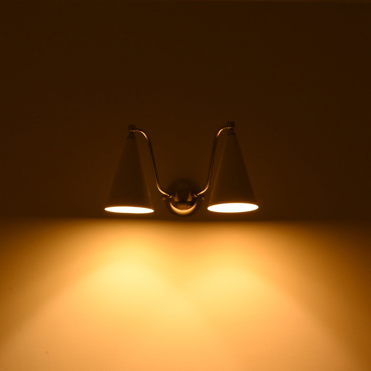 Delphi wall sconce measuring approximately 15 inches wide and 9 inches high with twin cone shades