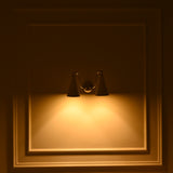 Modern two light cone wall sconce with sculptural ivory shades and reflective chrome brass arms