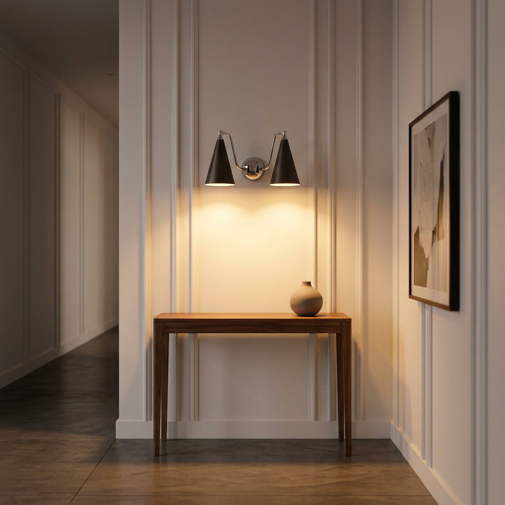 Statement double wall sconce with two ivory cone shades, curved chrome arms and warm focused lighting