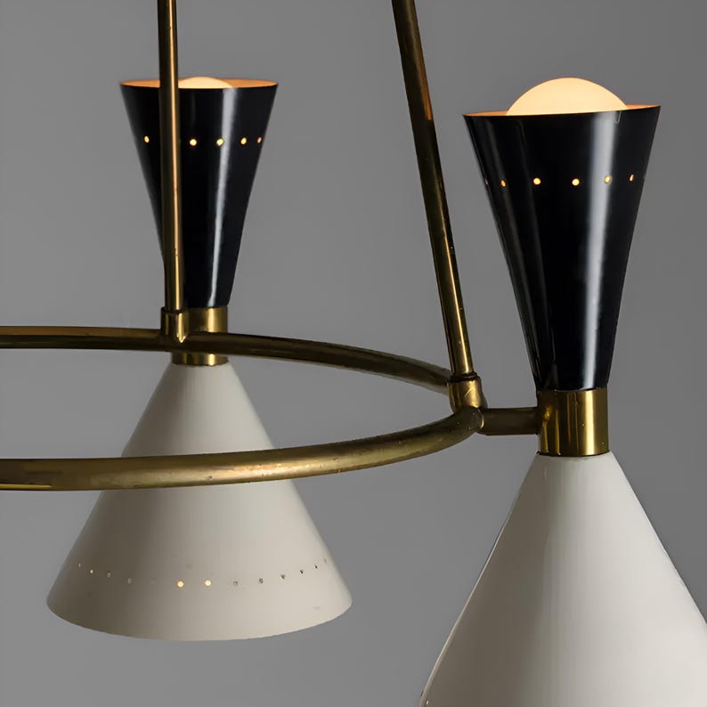 Close-up of Diabolo style chandelier showing black cone shades paired with brass arms and precision craftsmanship