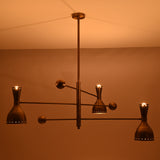 Mid-century inspired Diabolo brass chandelier casting an uplifting ceiling glow with elegant indirect lighting.