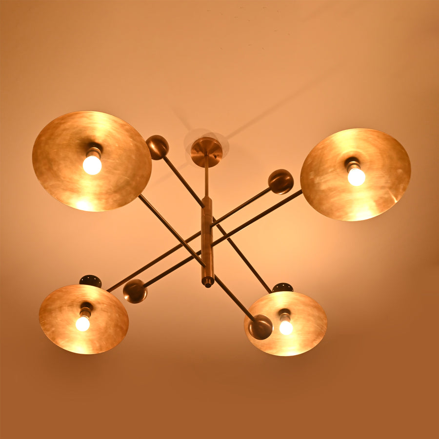 Front view of 8-light Diabolo chandelier crafted in brushed brass with sculpted bowl shades and black conical holders.