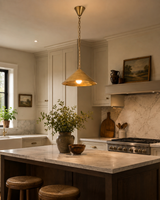 Dining room brass pendant lighting with wide cone shade creating a cozy and inviting atmosphere