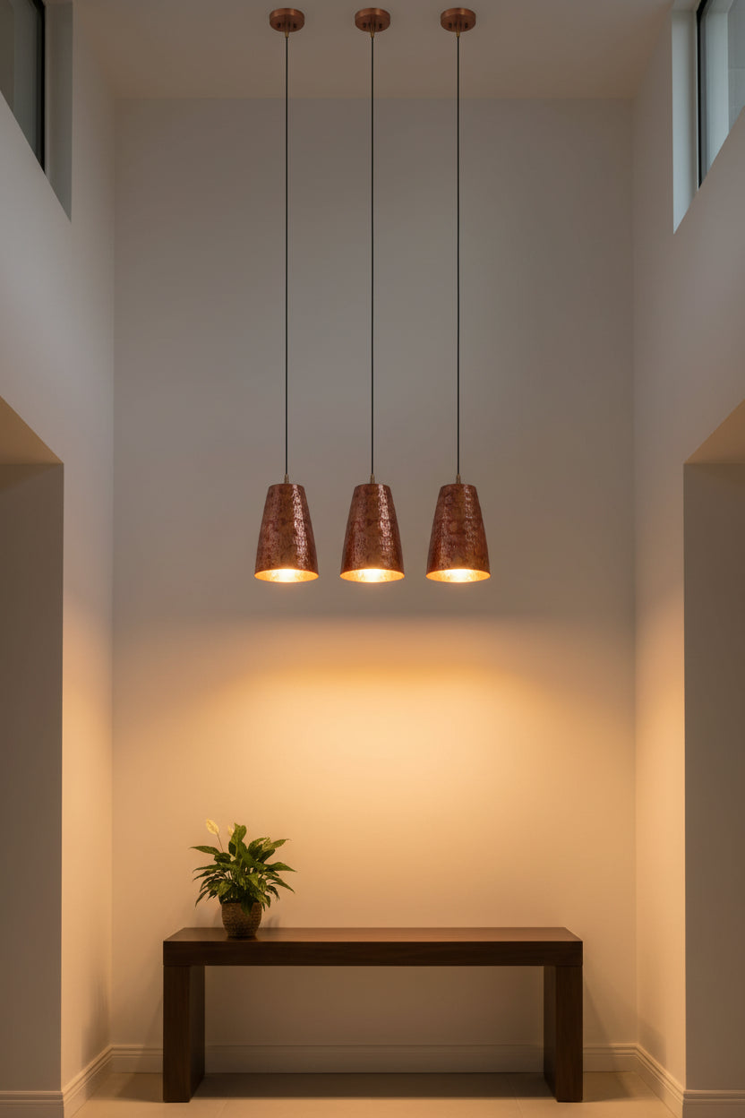 Copper pendant light installed above a dining table with red patterned shade and warm ambient glow for modern interiors