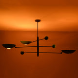 Disc chandelier creating soft indirect light patterns across the ceiling in a warm interior