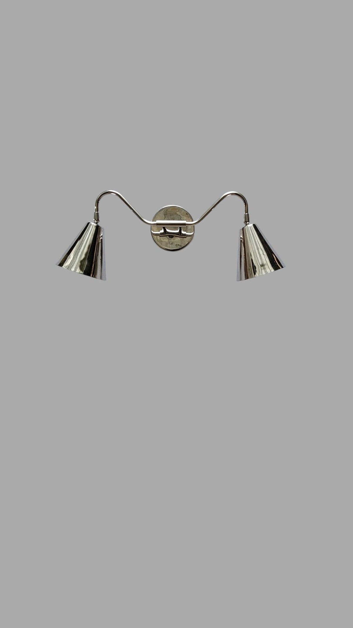 Minimalist front view of brass double cone wall sconce with modern design