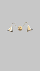 Modern brass wall sconce with double cone shades in polished metallic finish