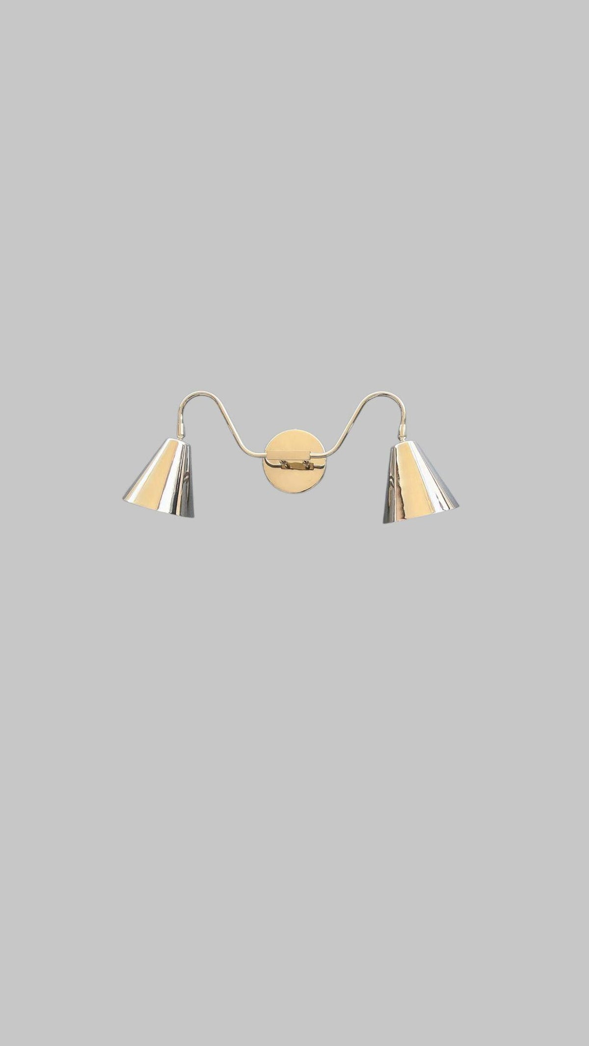 Symmetrical design of brass double cone wall sconce with two polished cone shades