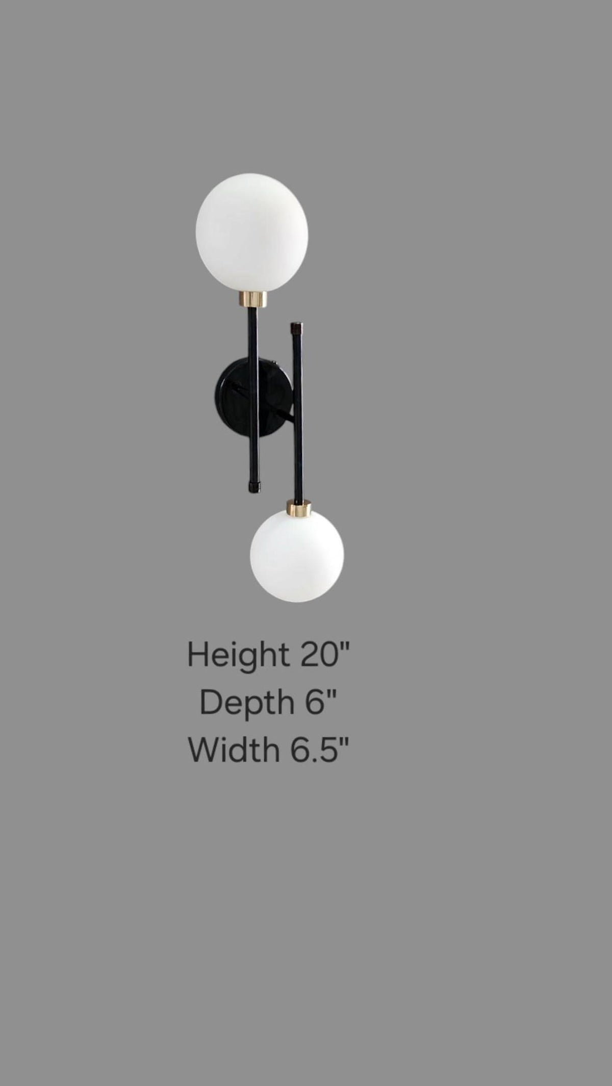 Dimensional image showing 20-inch height, 6.5-inch width, and 6-inch depth of black and brass double globe wall sconce.