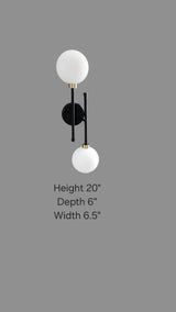 Dimensional image showing 20-inch height, 6.5-inch width, and 6-inch depth of black and brass double globe wall sconce.