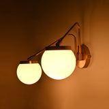 Double globe wall light shown illuminated, creating a warm glow for cozy bedrooms, hallways, and lounge spaces