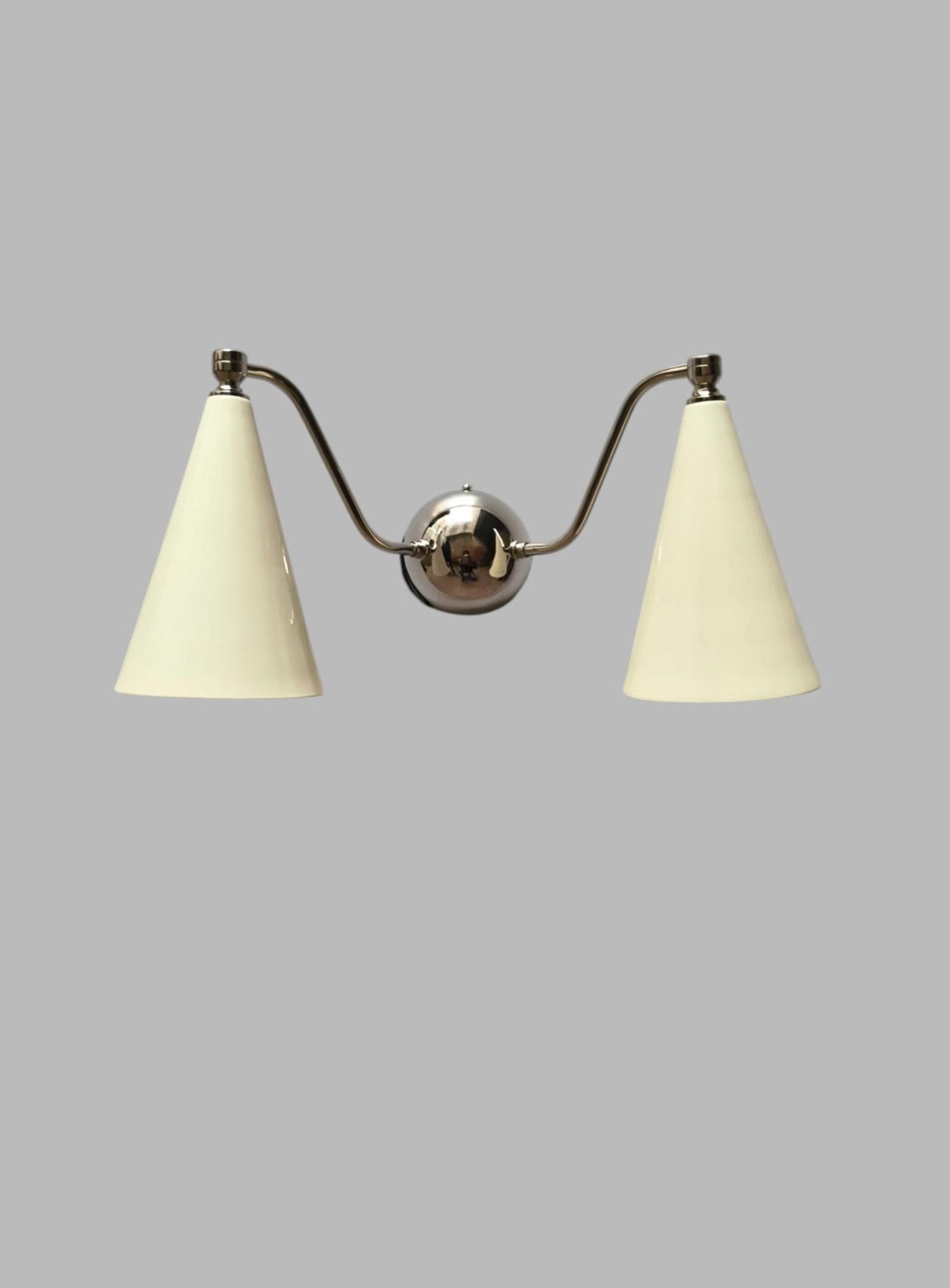Dual cone wall sconce with polished brass body and white cone shades, modern handmade lighting by Brass Leaf Studio.