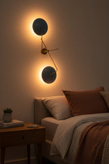 ual disc brass wall light with two large blue circular shades, brass arms, and round wall canopy