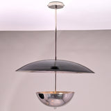 Dual-disc copper chandelier casting ambient light with hammered upper plate and polished lower dome