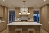 Dual G9 globe pendant lamp in brass patina finish shown illuminated with soft warm glow